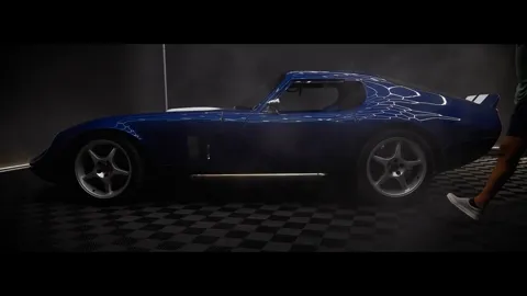 Shelby Daytona automotive video by MEM Films: blue coupe with white racing stripes lit dramatically in a dark garage