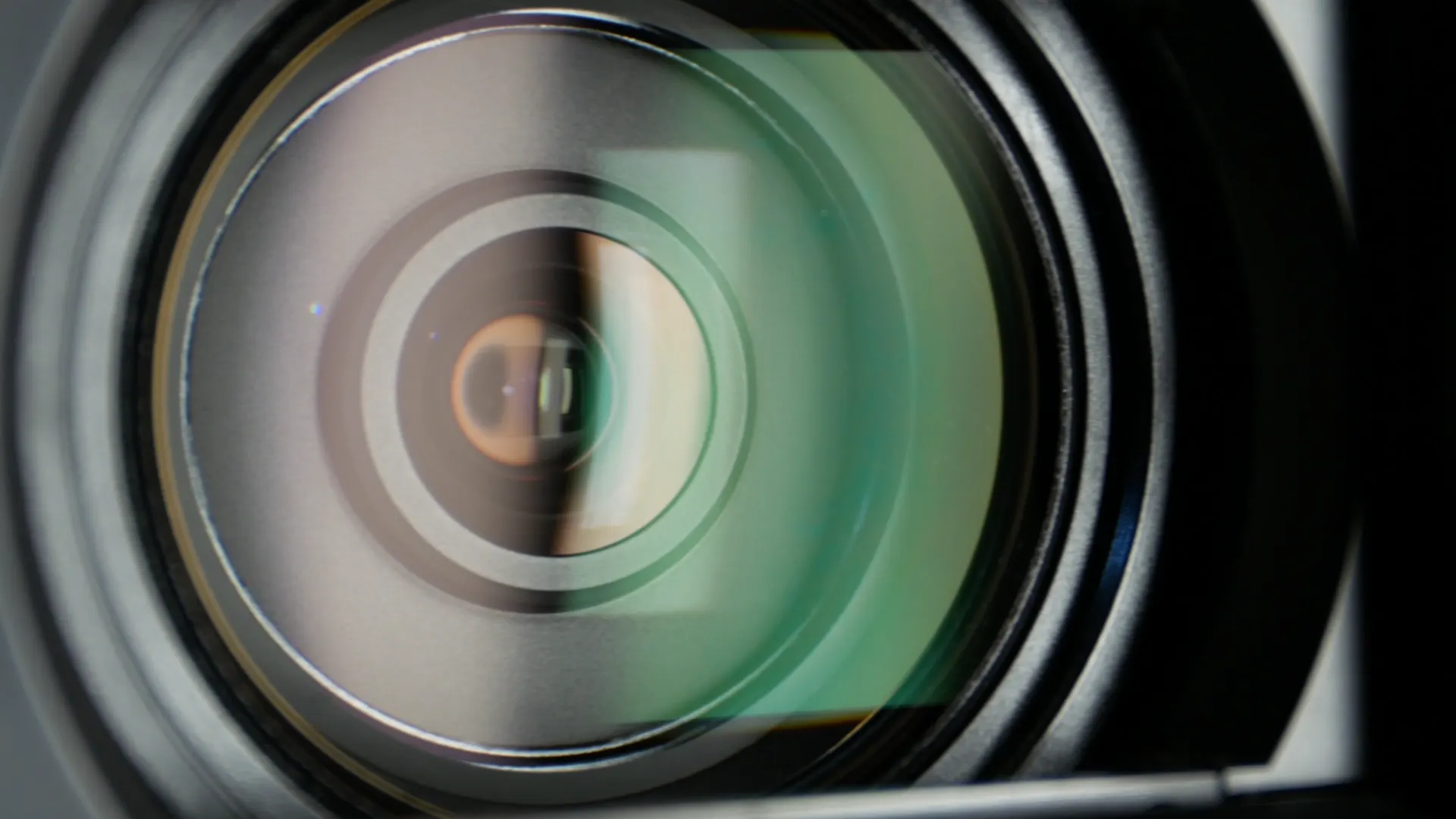 Close-up of a cinema camera lens behind MEM Films video production pricing