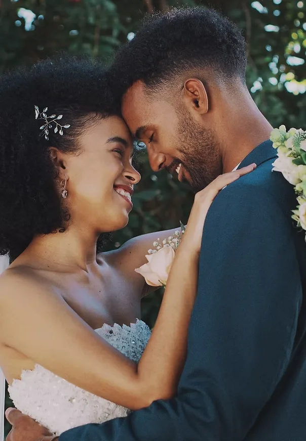 Event and wedding photography in St. Charles County: bride and groom embracing forehead to forehead among greenery