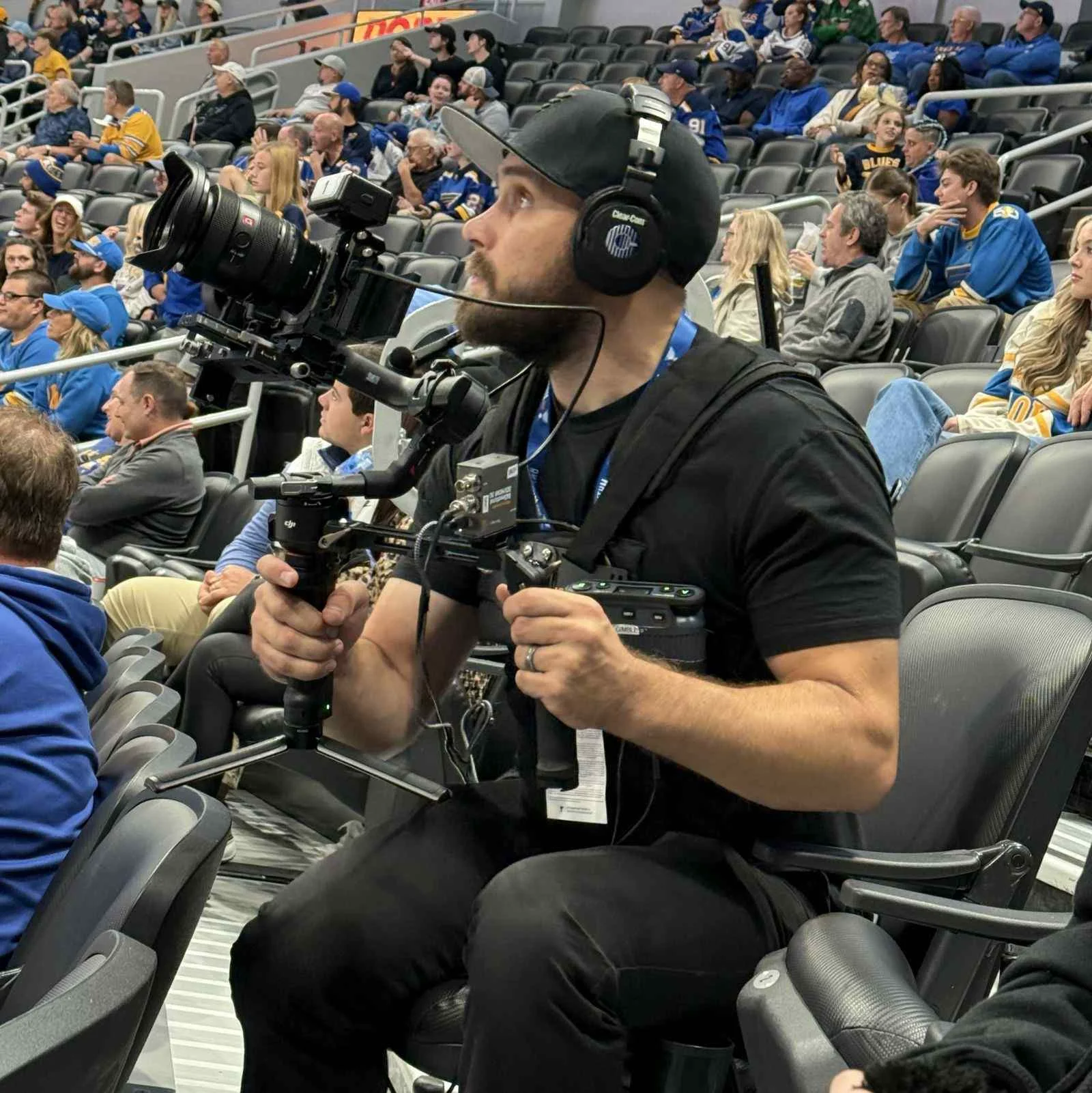 Video production in St. Louis, MO: Mark Mattei of MEM Films operating a gimbal-mounted camera from the stands at a St. Louis Blues game