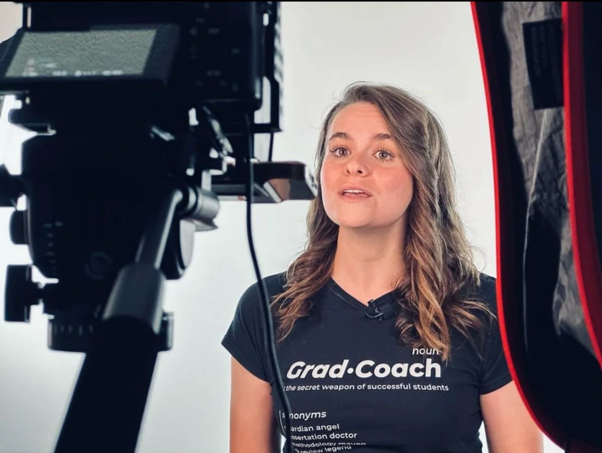 Brand video production in Wentzville, MO: Grad Coach spokesperson on a MEM Films studio set between a cinema camera and a softbox light