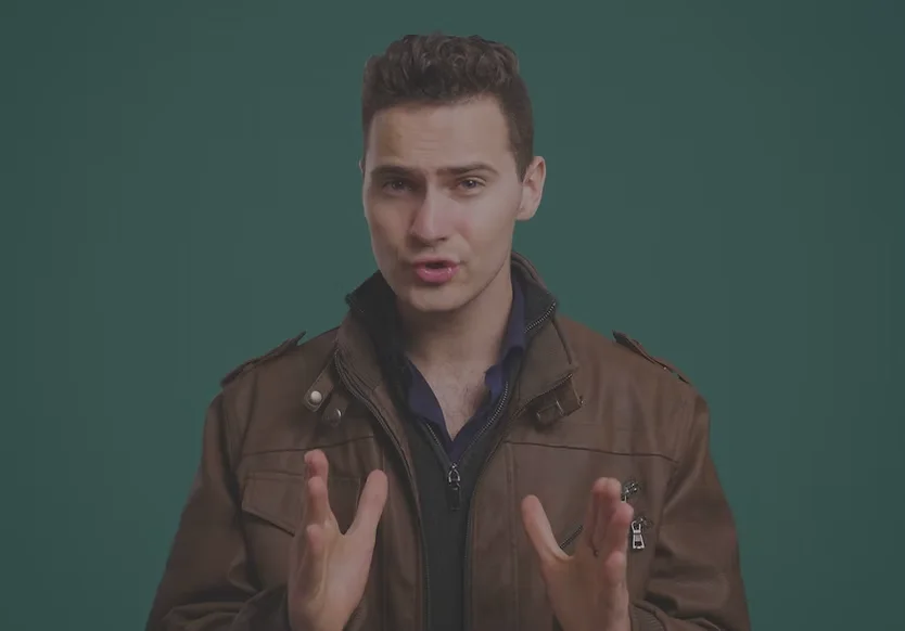 Corporate video production for Chesterfield, MO companies: presenter in a brown leather jacket gesturing to camera against a teal backdrop