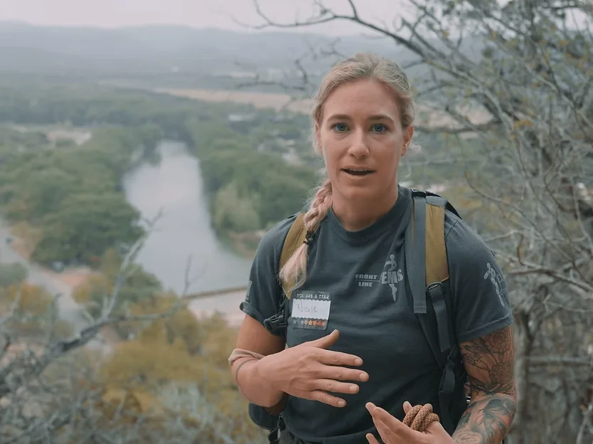 Testimonial video production for Lake Saint Louis, MO businesses: woman with a backpack interviewed outdoors above a winding river