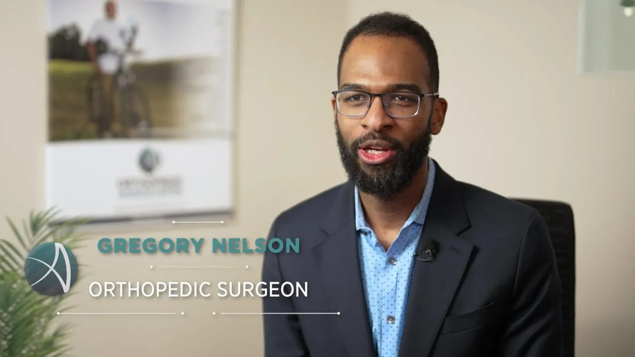 Gregory Nelson, orthopedic surgeon at Orthopedic Associates, interviewed in a suit with a lower-third name title