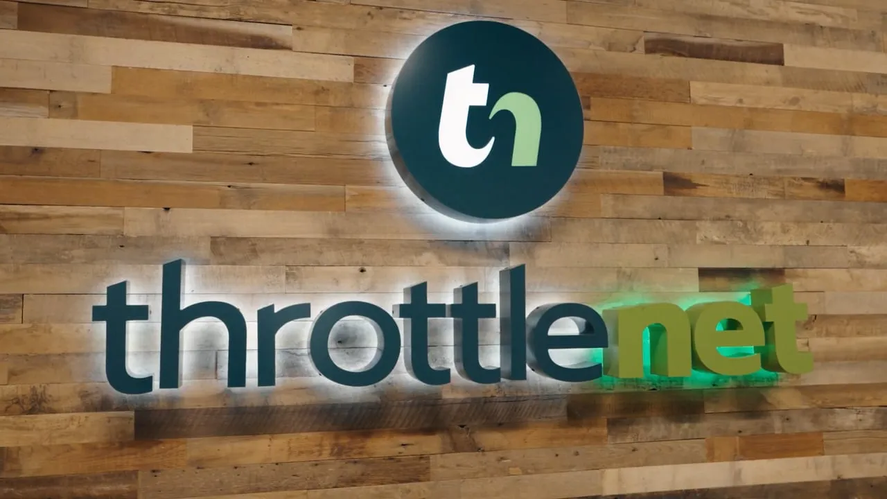 ThrottleNet co-managed IT services video: glowing ThrottleNet logo mounted on a reclaimed wood wall