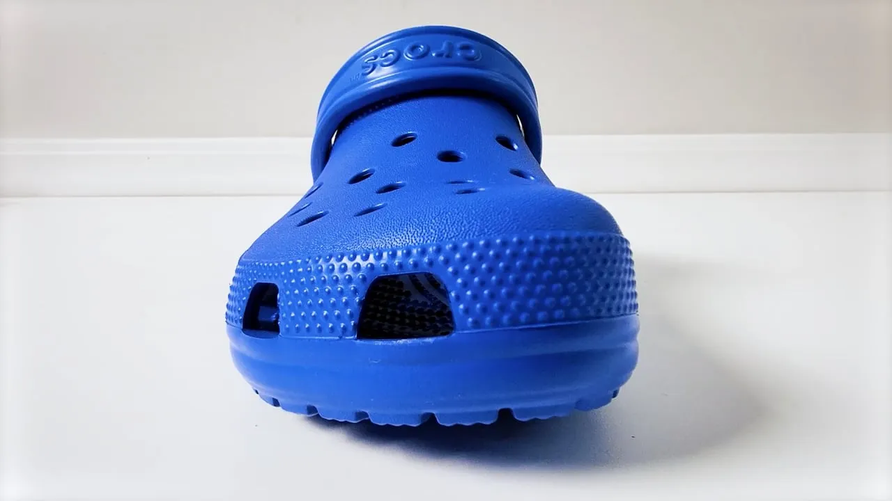 Promotional video production: blue Crocs classic clog on a white surface from a MEM Films product promo