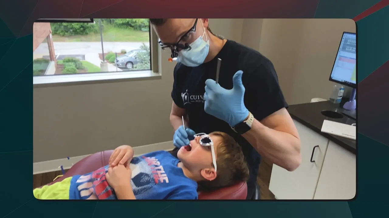 Little Smiles pediatric dentistry promo: dentist in a mask and blue gloves examining a young patient wearing sunglasses